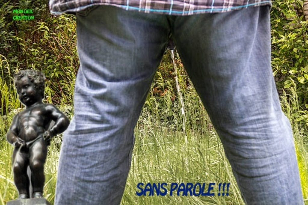 Man in jeans relieves himself on a meadow